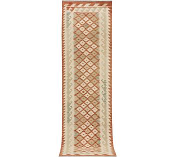 An Afghan kilim runner, c. 296 x 78 cm.