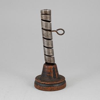 An 18th century wood and iron candlestick.