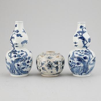 A pair of blue and white 'double gourd' vases, Qing dynasty, late 19th century, and a ceramic jar, south east asian.