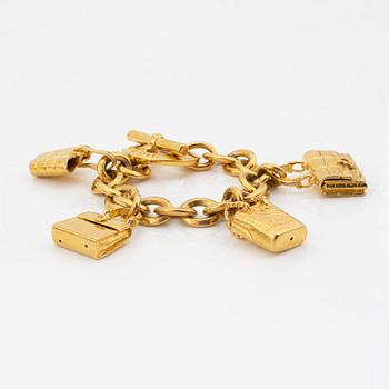 Céline, a gold tone charm bracelet.