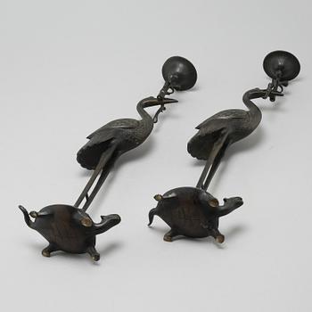 A pair of bronze candlesticks, China, 20th Century.