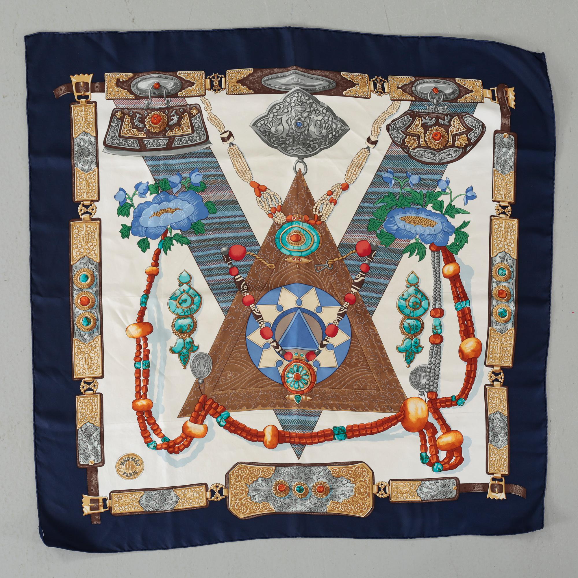 HERMÈS, "Tibet" scarf, and brooch.