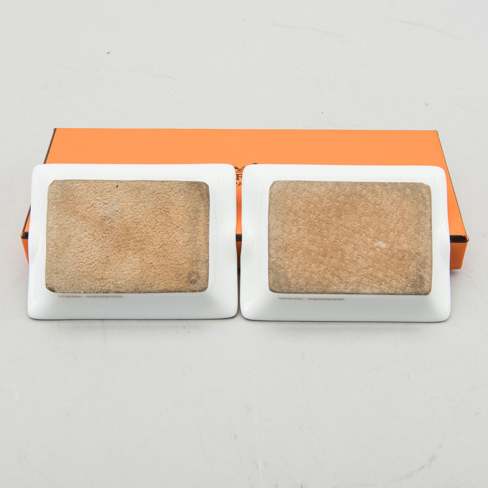 HERMÈS, a pair of porcelain ashtrays.