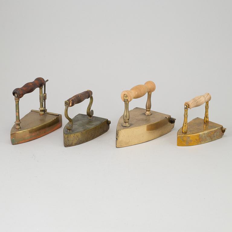 FOUR 19TH CENTURY BRASS IRONS.
