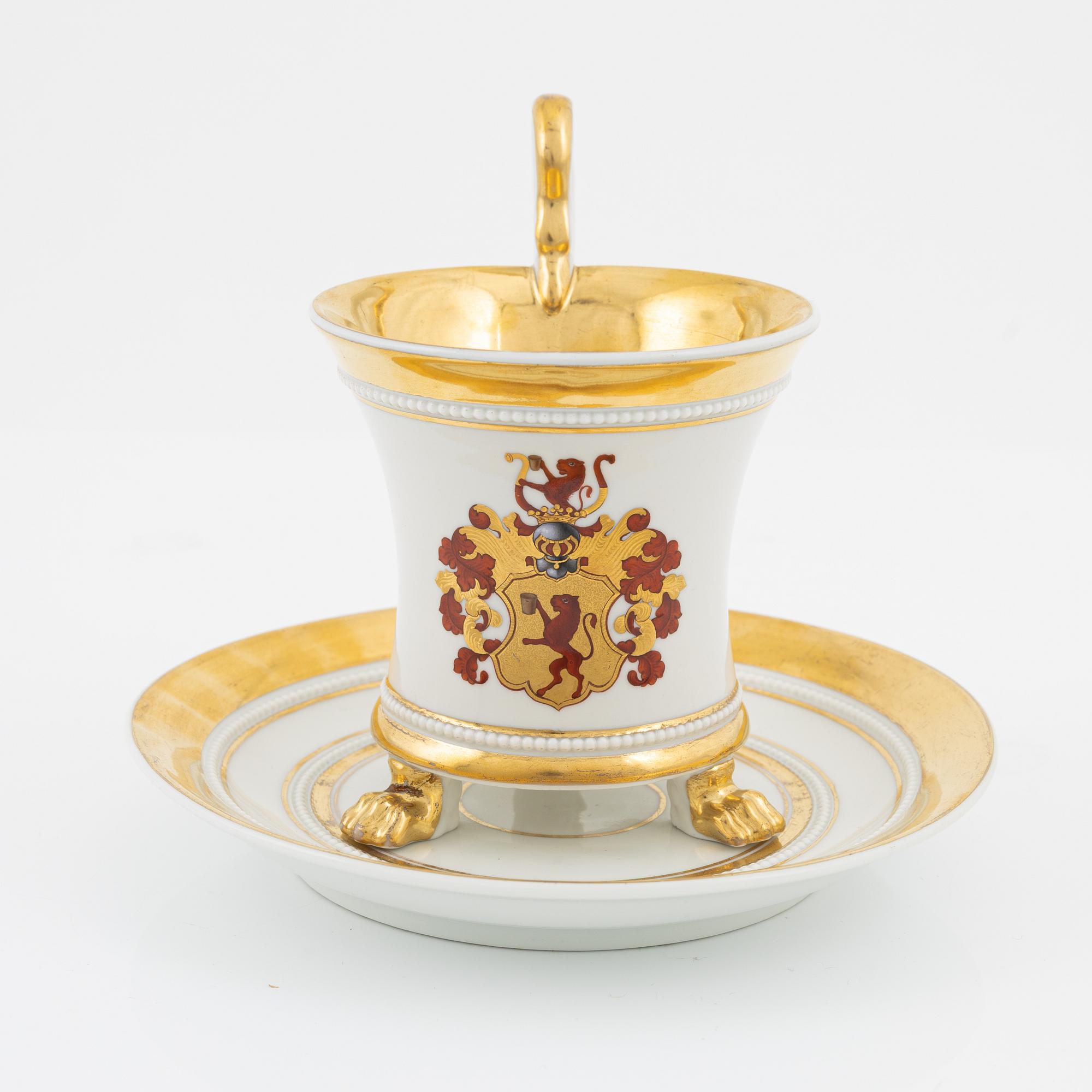 An Empire style porcelain cup and saucer, Germany, circa 1900.