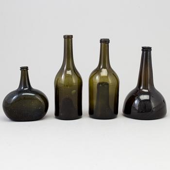 A set of four 18th/19th century hand blown glass bottles.