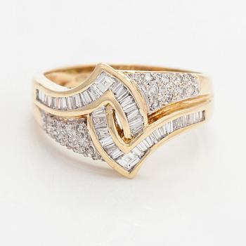 A 14K gold ring, set with brilliant and baguette-cut diamonds, Finnish hallmarks.