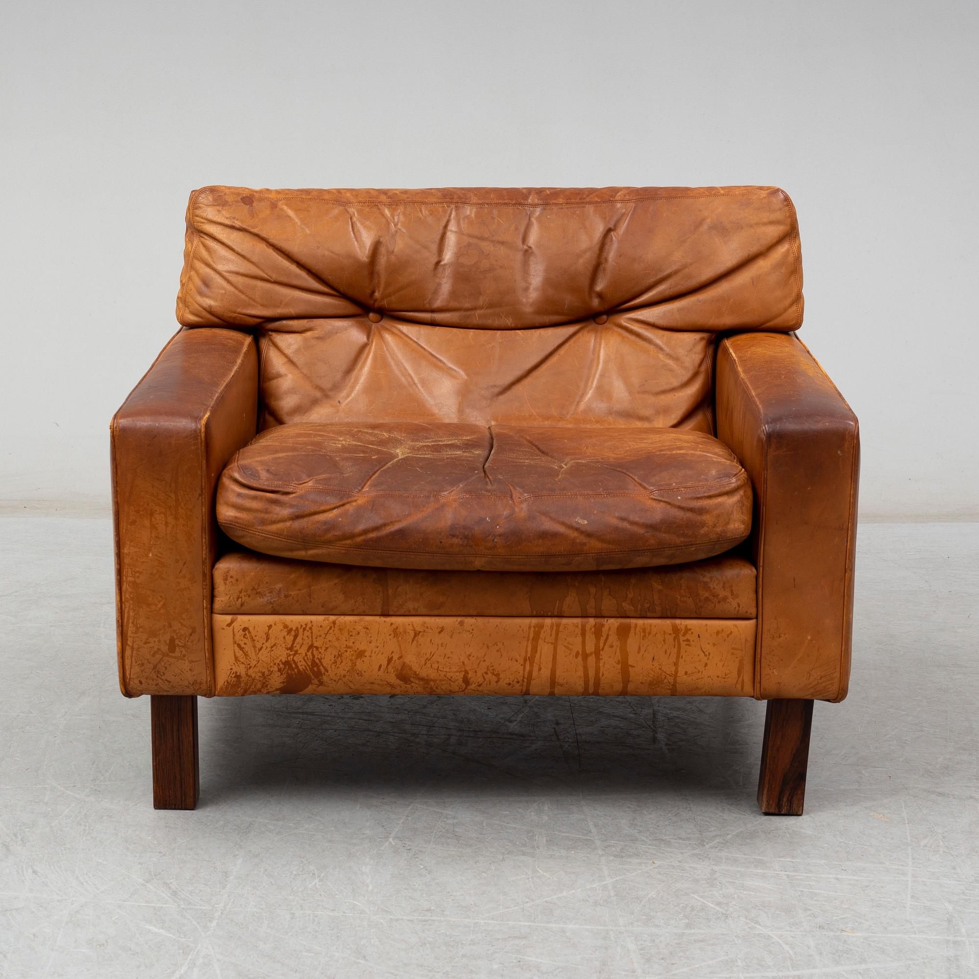 A 1960's/1970's leather covered easy chair with rosewood legs.