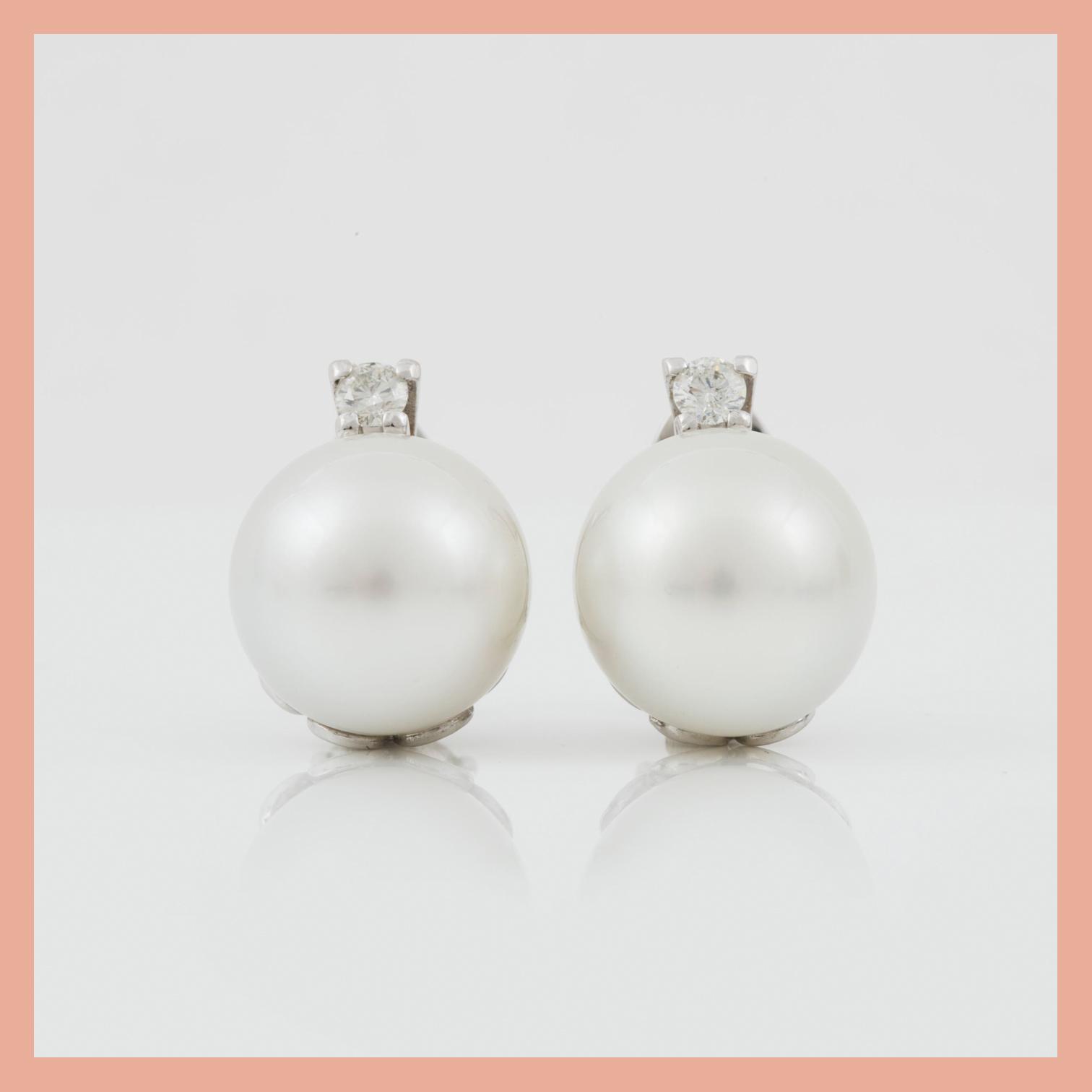 A pair of cultured South sea pearl and diamond earrings. Total carat weight of diamonds circa 0.35 ct.