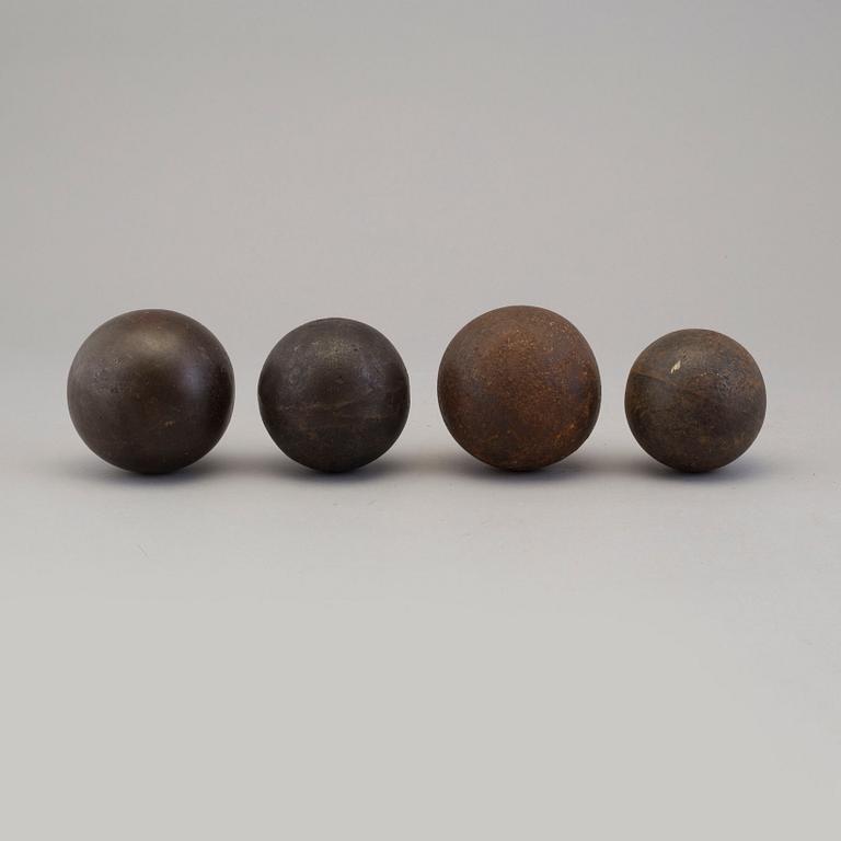Four iron balls, 18th/19th century.