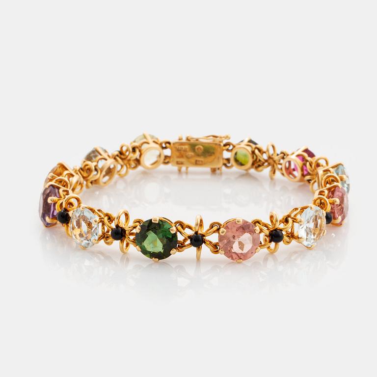 A WA Bolin bracelet in 18K gold set with coloured gemstones.