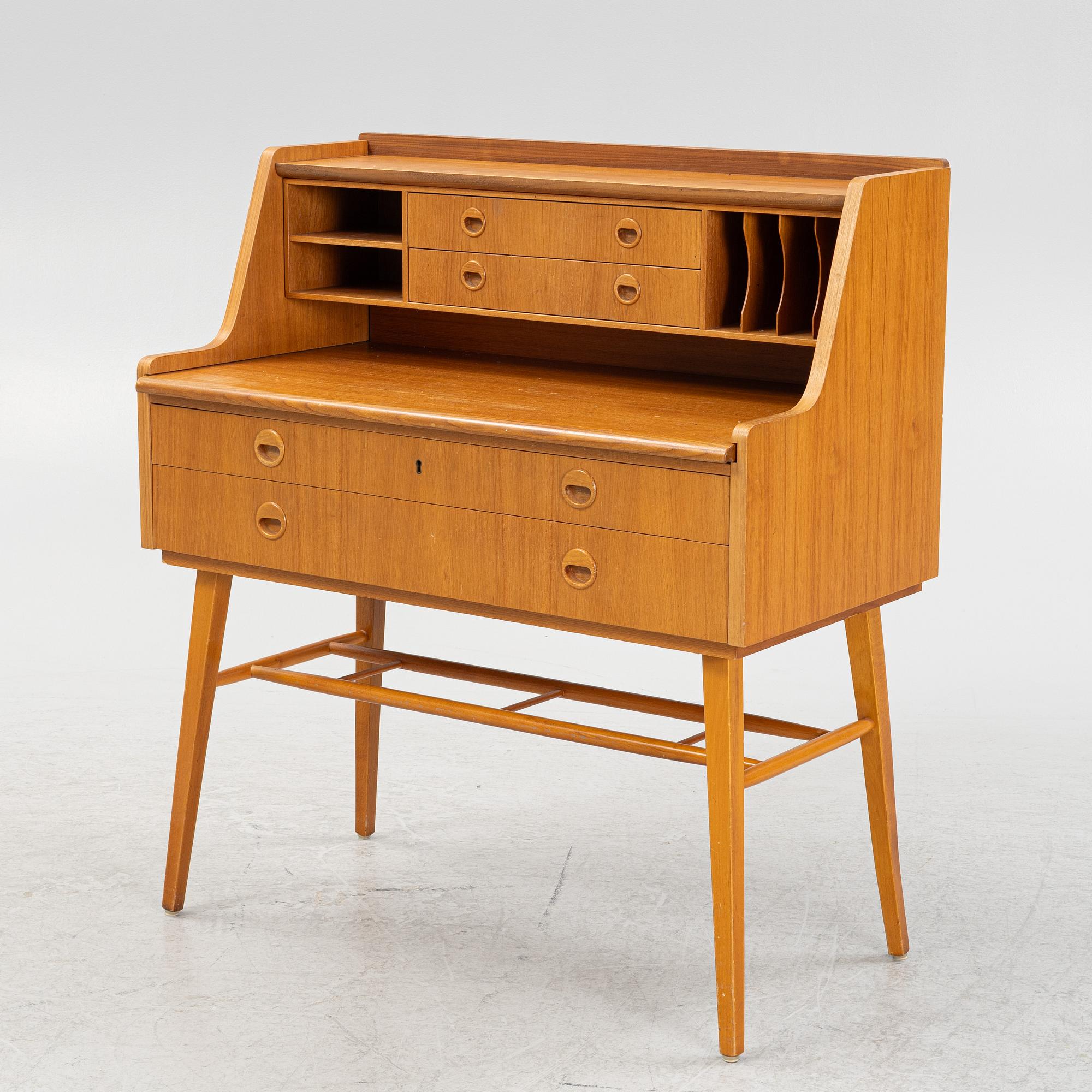 A teak-veneered desk, mid 20th century.