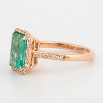 Emerald-cut emerald and brilliant-cut diamond ring.