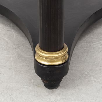 A contemporary empire style sheet metal center table.