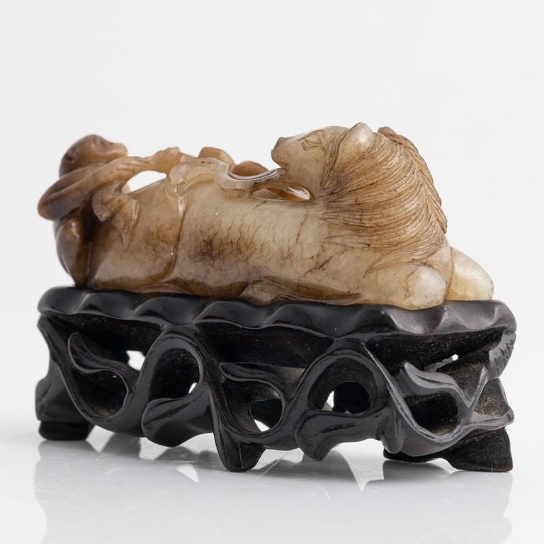 A Chinese sculptured figure of a reclining horse, 20th Century.