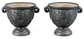 A pair of Baroque-style iron garden urns.