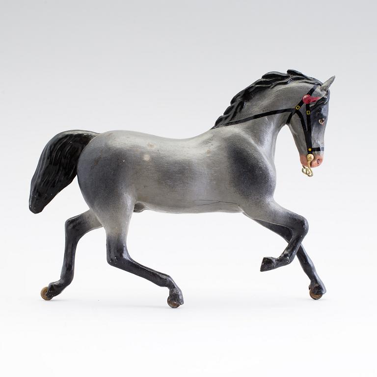 A painted tinplate toy horse ca year 1900.