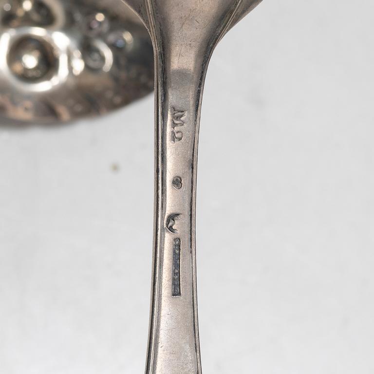 Seven silver spoons, including English and Swedish hallmarks.