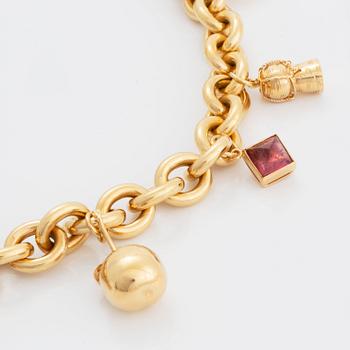 An 18k gold charm necklace.