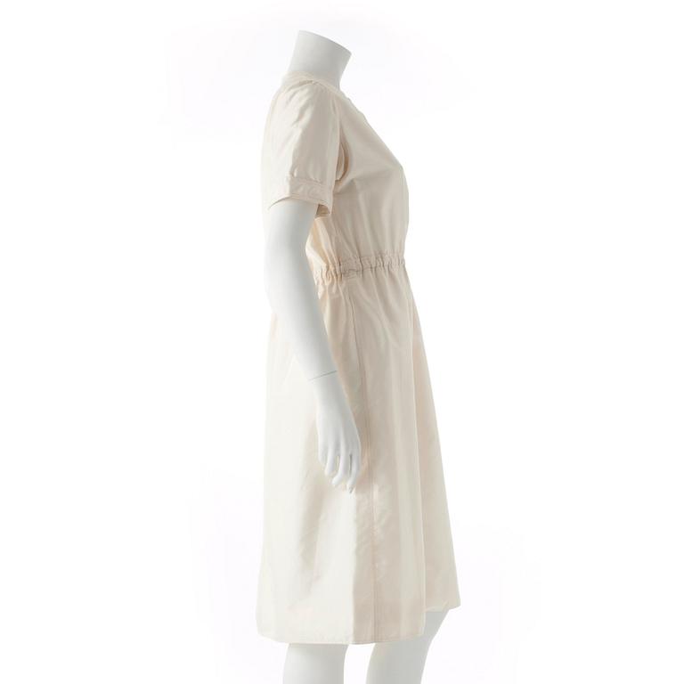 COURRÈGES, a creme colored silk dress.