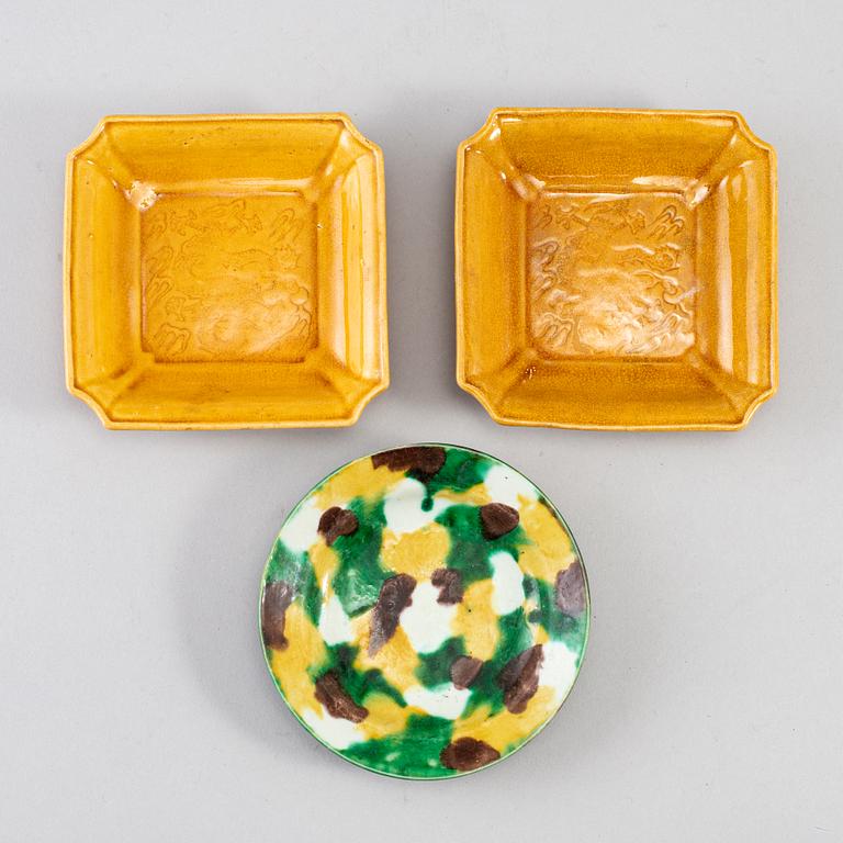 Two yellow glazed dish and an egg and spinach glazed dish, Qing dynasty, 18th/19th Century.