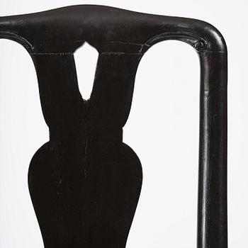 A set of eight black Swedish rococo chairs.