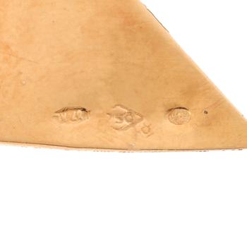 an 18K gold broosch with rubies, possibly synthetic.