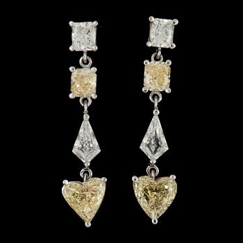 192. A pair of fancy yellow and colourless diamond earrings.