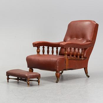 A late empire armchair with stool, mid 19th century.