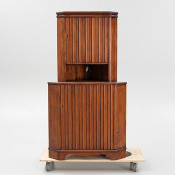 A stained pine corner cabinet, second half of the 20th century.