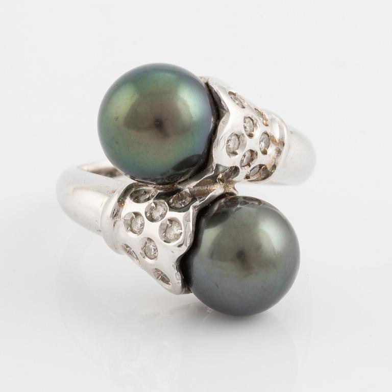Cultured black pearl and brilliant cut diamond cross over ring.