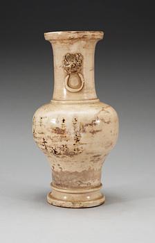 A cream glazed vase, Ming dynasty, with an inscription that dates it to 1608.