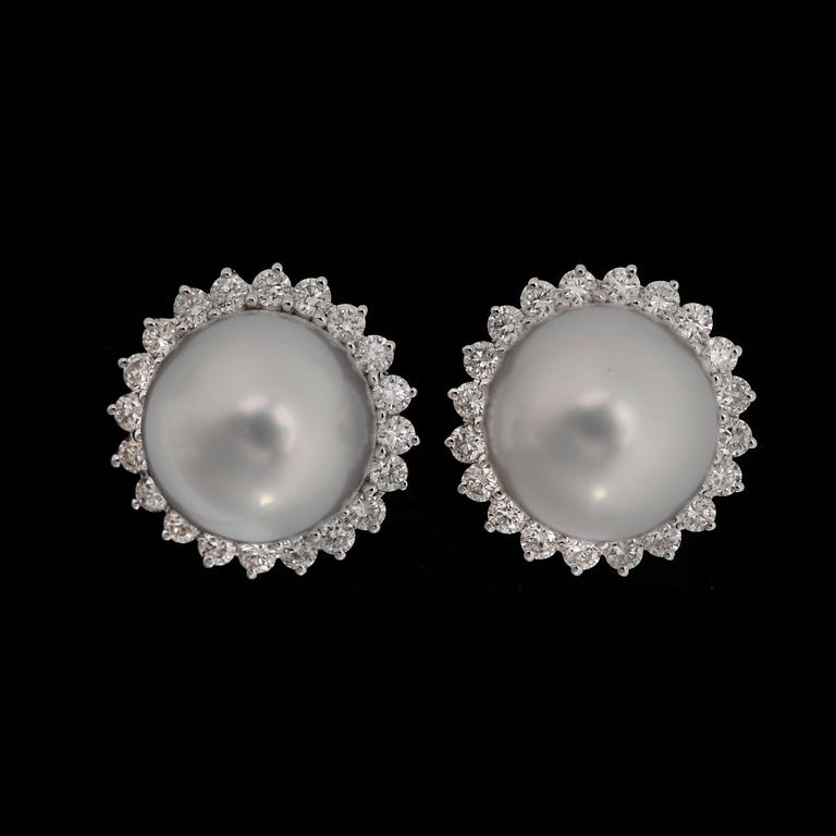 A pair of cultured South sea pearl earrings set with brilliant cut diamonds, tot. app. 0.80 cts.