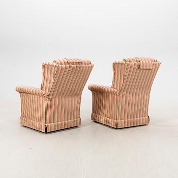 A pair of easy chairs with footstools by Bröderna Andersson 21st century.