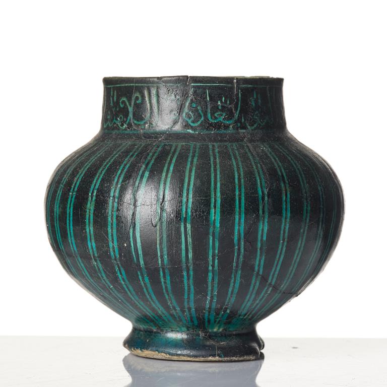 A Kashan Silhouette ware turquoise glazed pottery jug, central Iran, circa 1200.