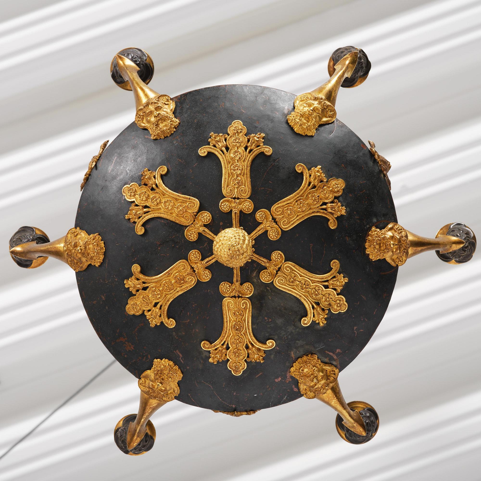 A patinated and ormolu six-light Empire chandelier, Stockholm, first part 19th century.