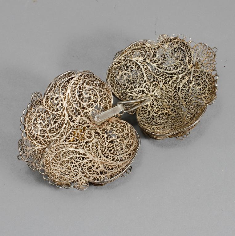 DRÄKTSPÄNNEN, ett par, silver, omkring 1900. Vikt 125 gram.