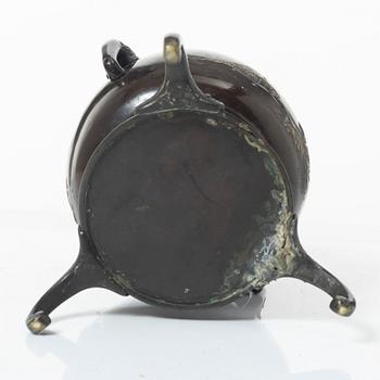 A Japanese bronze tripod vase, Meiji period (1868-1912).