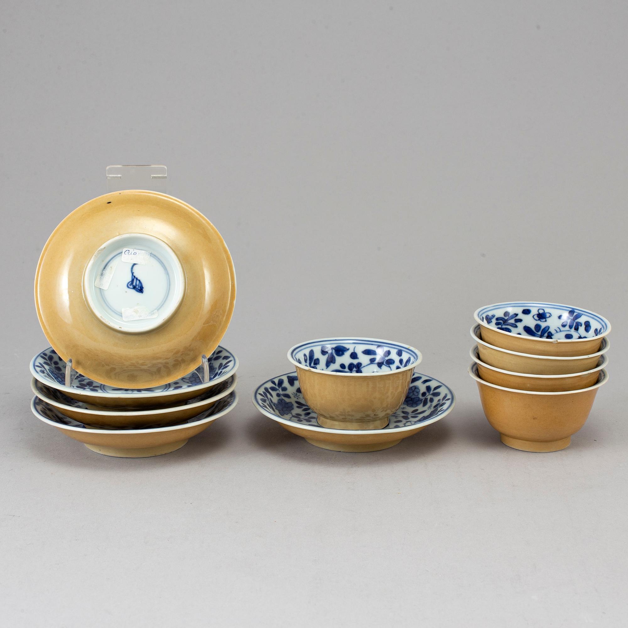 Five blue and white and cafe au lait glazed cups with dishes, Qing dynasty, Qianlong (1736-95).