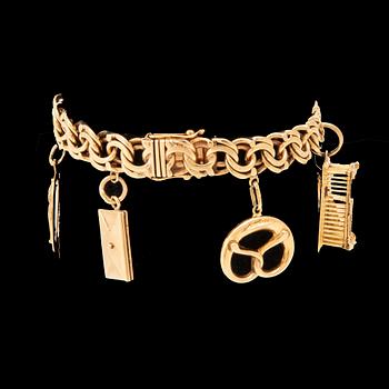 An 18K gold bracelet with charms.