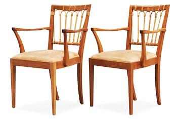 A pair of Josef Frank mahogany and ratten dining chairs.
