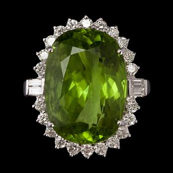 A peridote, 13.16 cts, and brilliant cut diamond ring.