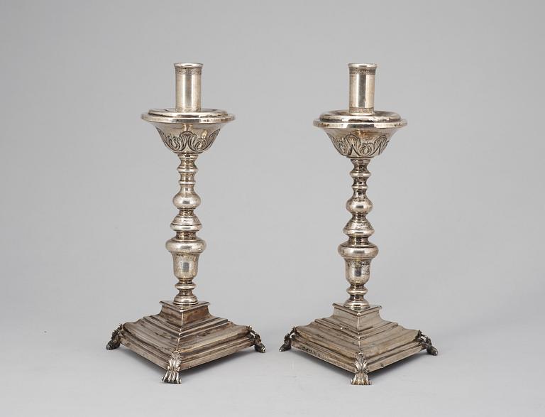 A pair of possebly Spanish or South American 18th century candelsticks, unidentified makers mark.