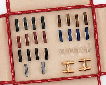 A pair of cufflinks signed Cartier with changeable  details in different gemstones.