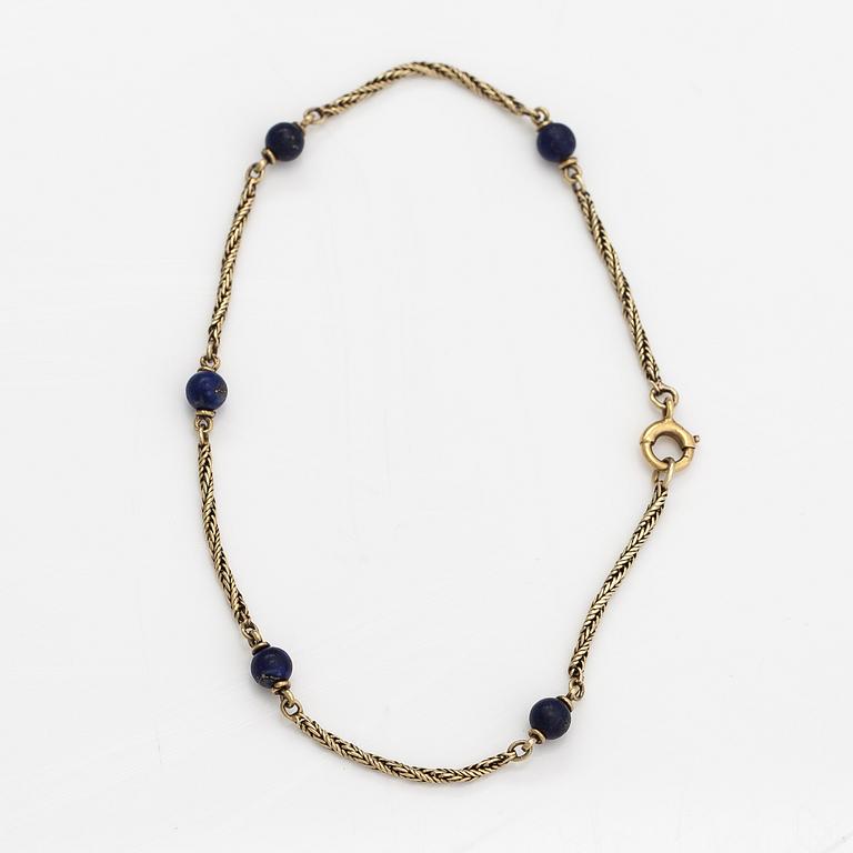 A 14K gold bracelet with lapis lazuli.