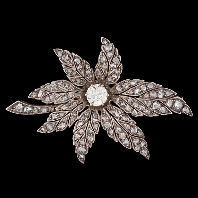 An antique- and rose cut diamond brooch of floral design, center stone app. 1.10 ct.
