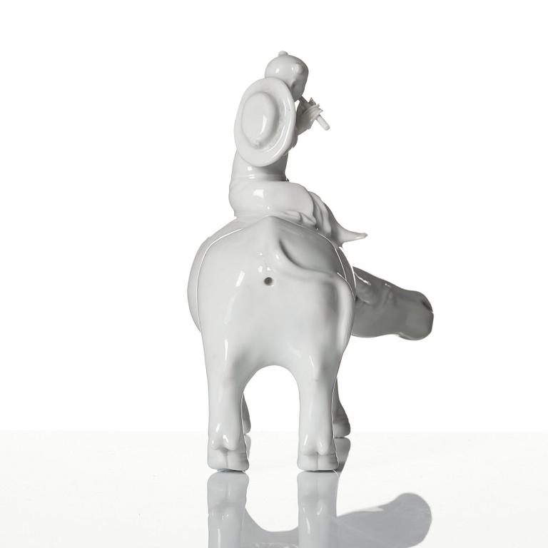 A blanc de chine figure of a boy on an ox, late Qing dynasty.