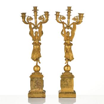 A pair of six-branch gilt bronze Empire candelabra, Paris, early 19th century.