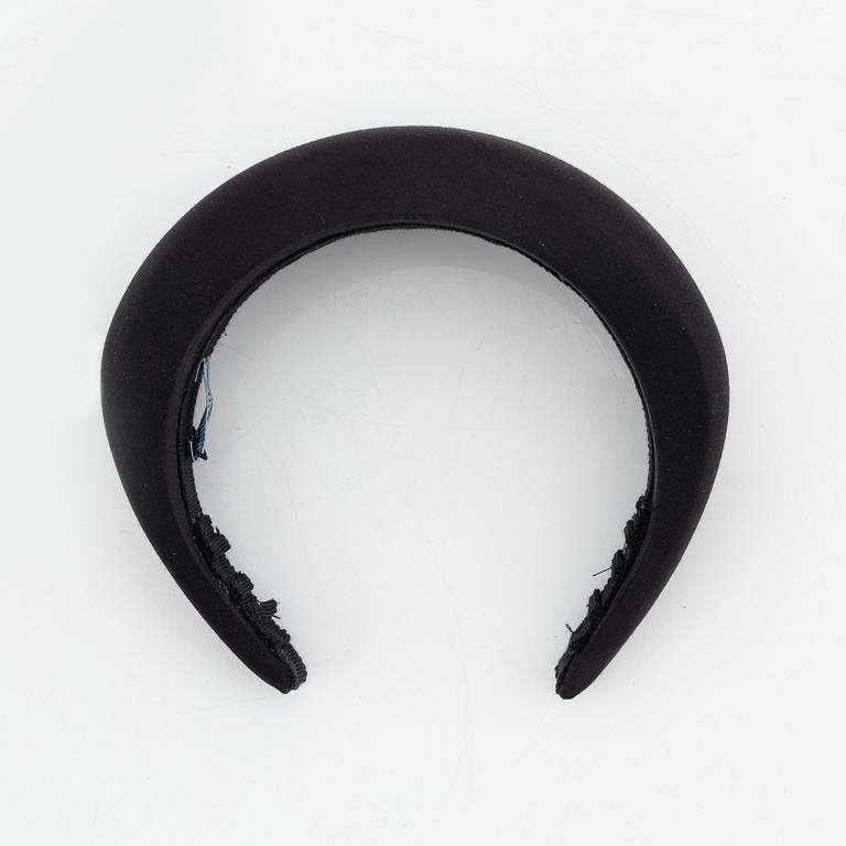 Prada, a black silk hair accessory.