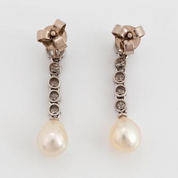 A pair of platinum and 18K white gold earrings set with pearls and old- and eight-cut diamonds.